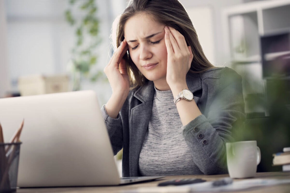 Woman has headache at work