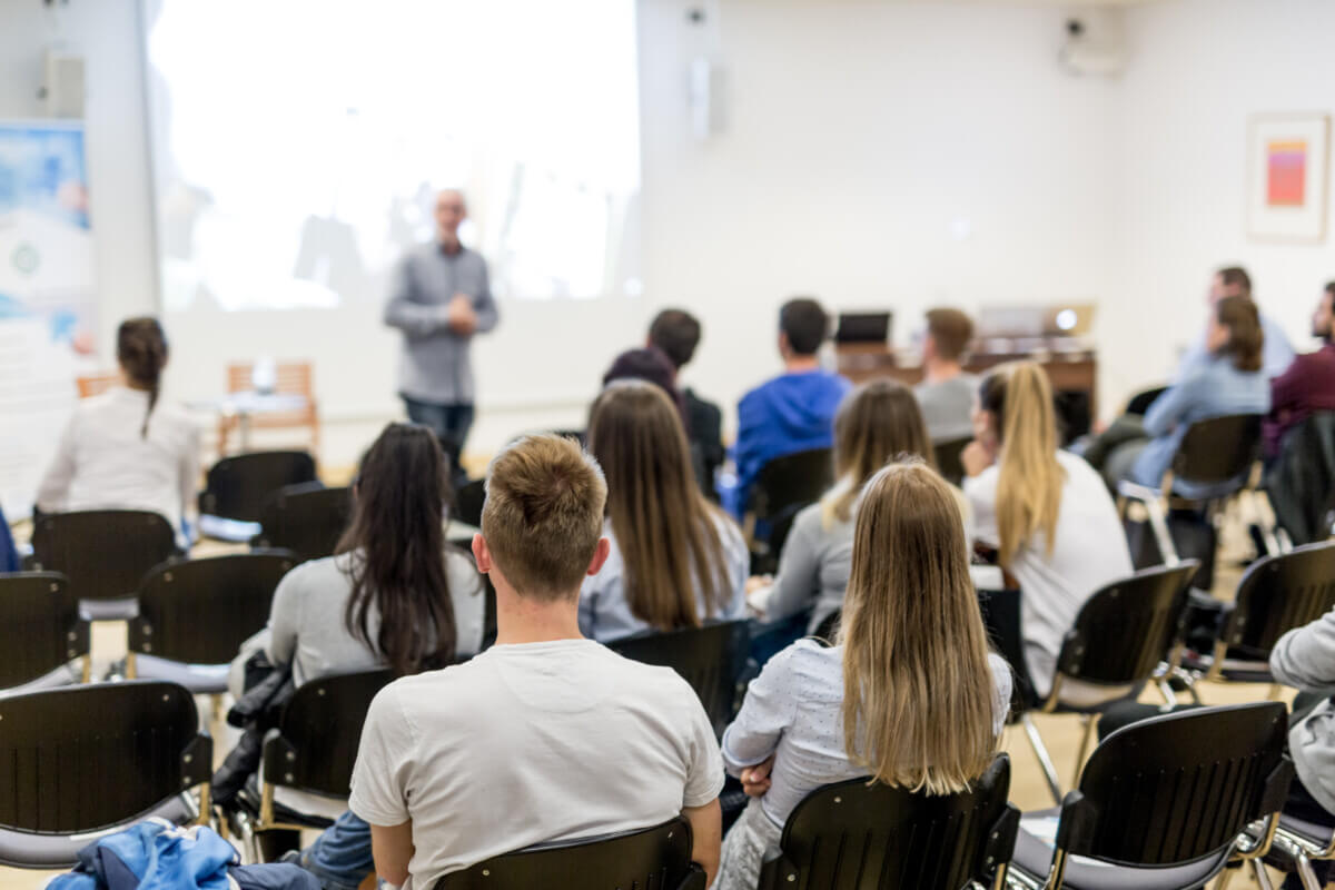 Professor lecturing in lecture hall at university.