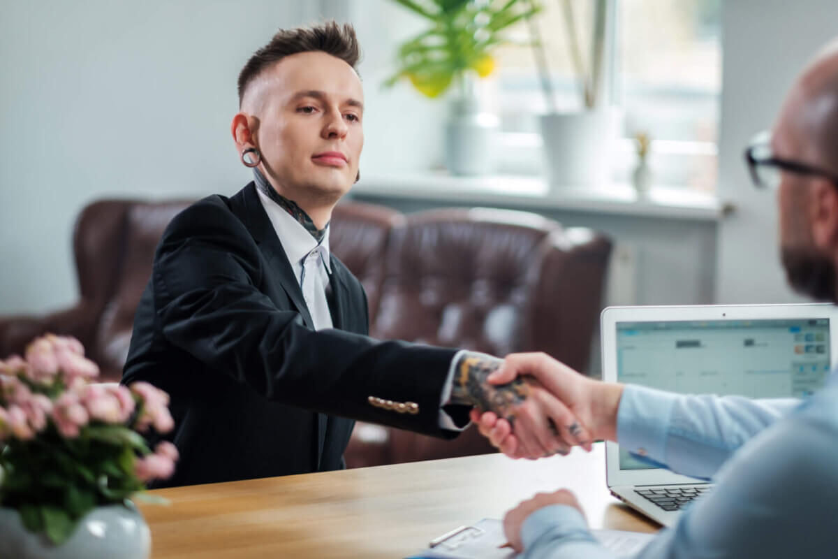 Man with tattoos, piercings on job interview
