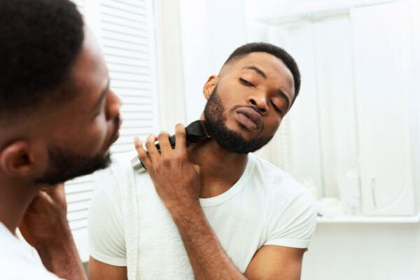Man trimming his beard in the bathroom