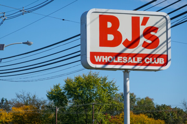 A red sign for BJ's Wholesale club as seen on the side of a road