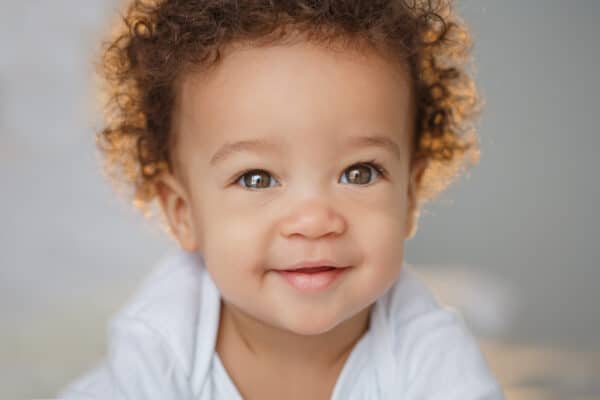 Beautiful baby with curly brown hair