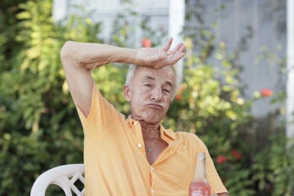 Hot, sweaty older man outside during heat wave