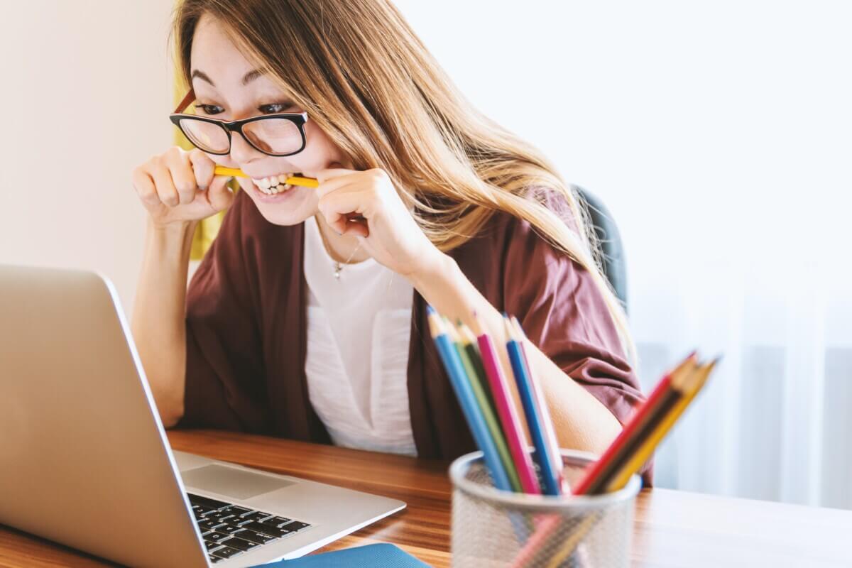 Student studying and biting pencil.