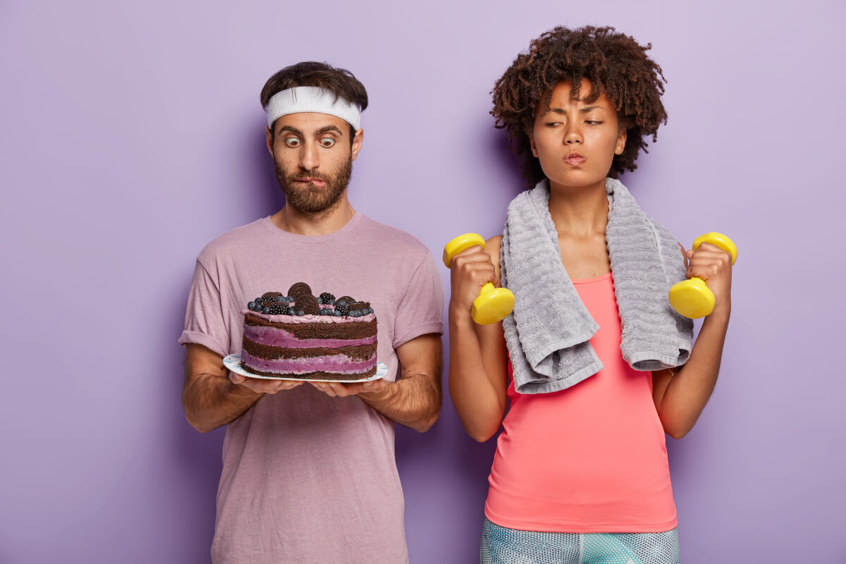 Couple distracted by cake while working out