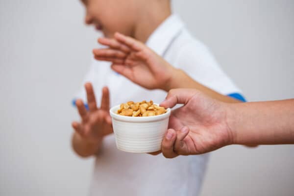 A boy refusing peanuts