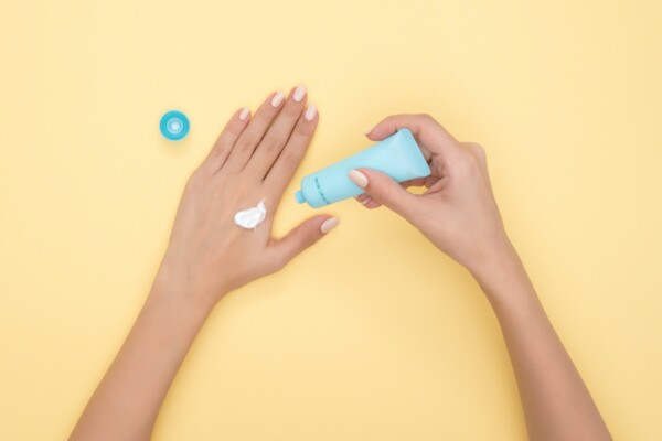 Hands applying hand cream