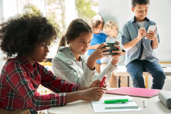 Students using smartphones in classroom.