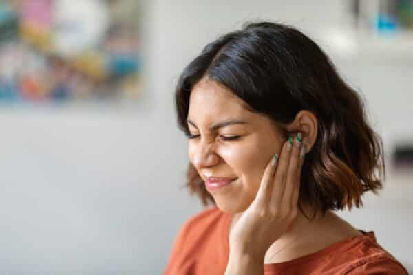 Woman with tinnitus (ringing in ears)