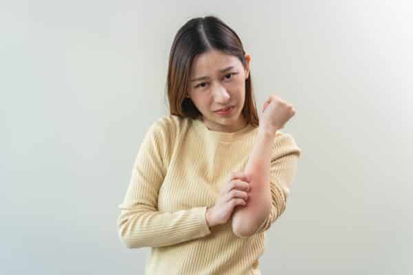 A woman scratching an itch
