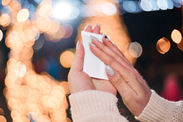 A woman holding a hand warmer