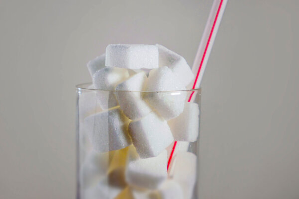Sugary drinks concept: Sugar cubes in a glass