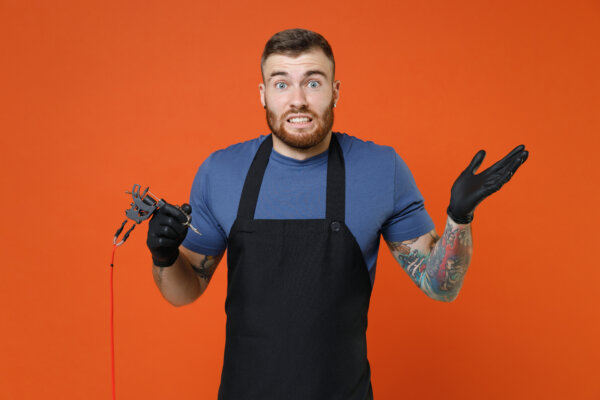 Tattoo artist looking confused