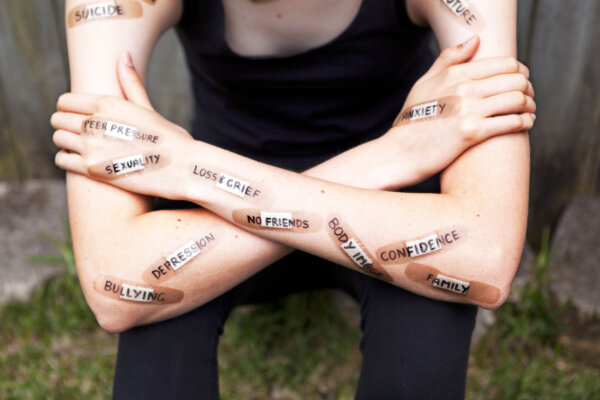 Teen with bandages showing different mental health struggles