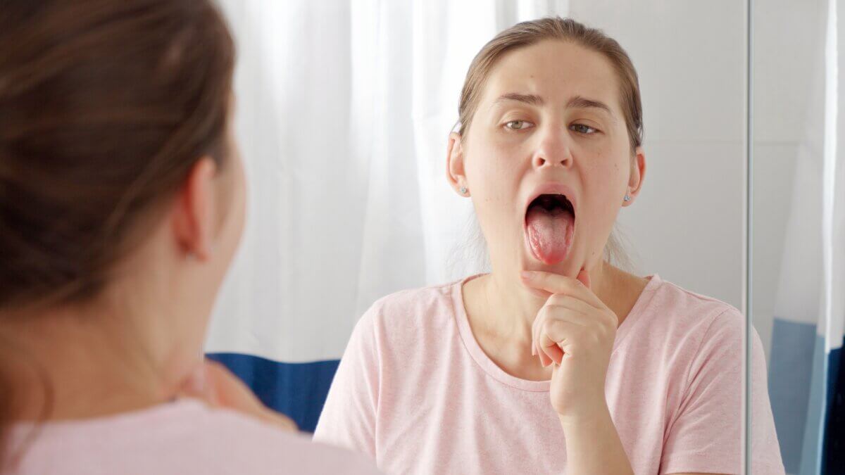 Woman checking her tongue and mouth