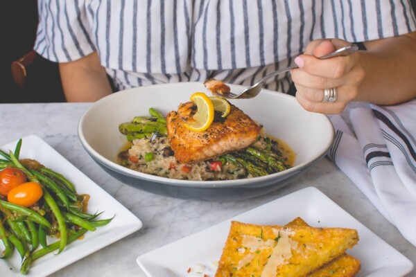 image of person eating fish for dinner